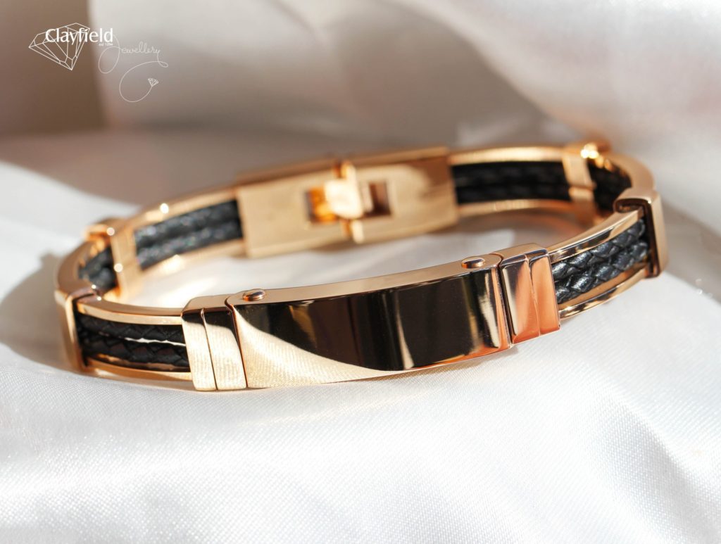 Mens bangle on white silk background